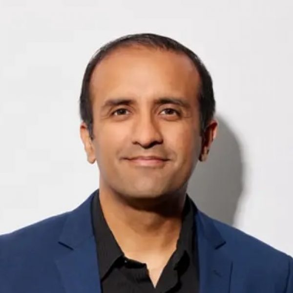 Dr. Raj Panjabi headshot in a blue suit and black shirt.